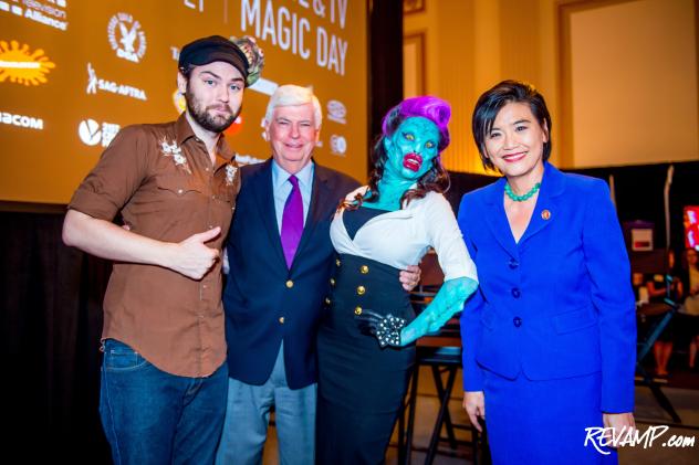 MPAA CEO/Chairman Chris Dodd and Congresswoman Judy Chu pose with a Syfy makeup artist and his 'Fish Lady' creation.